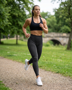 Woman running in the park in Fellstride women's black seamless leggings