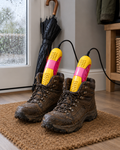 Yellow Hearthdry electric shoe dryer drying muddy walking boots in a British hallway on a rainy day