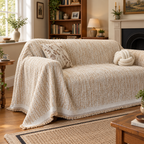 Side view of the champagne throw draped over the sofa arm and seat