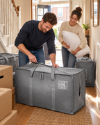 Packing a duvet into a grey Stowley storage bag on moving day