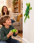 Boy steering the green Scuttleby remote control lizard up a living room wall