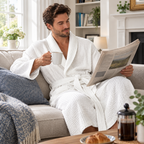 Man relaxing in the white dressing gown with the Sunday papers