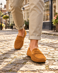 Caramel Chelsworth faux suede loafers worn on a cobbled English market-town lane