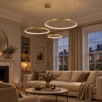 Gold ring pendant light glowing in a modern British living room