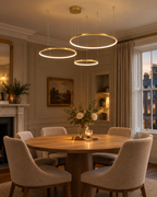 Aldgate three-ring gold LED pendant light above a dining table